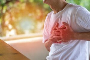 Blog 3 Heart Burn Or Pericarditis Disease Concept. Man's Hands On His Chest.